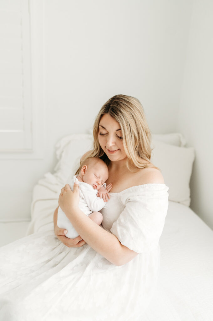 Mommy holding her new baby in newborn photos