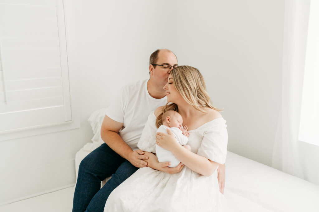 Dad and Mom with their new baby in newborn photos