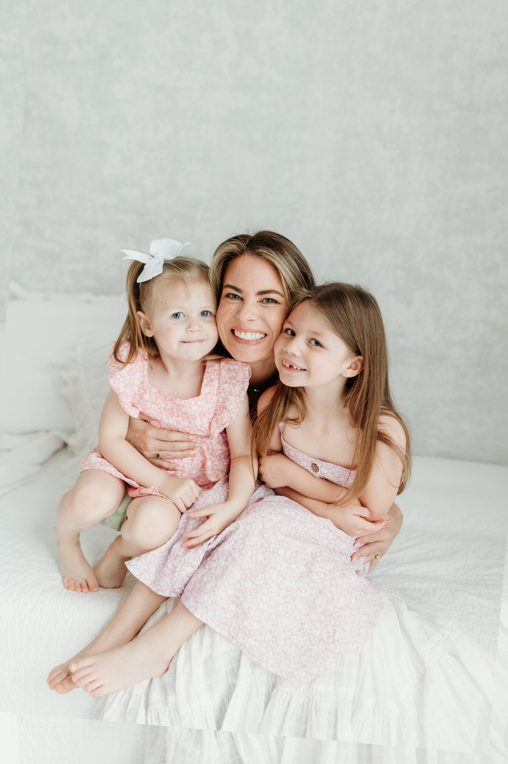Mom and her two daughters hugging during an Atlanta Mother's Day photoshoot